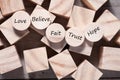 Wooden cube with inspirational text Faith, trust, believe, hope and love. Beautiful wooden table background. Business and Faith Royalty Free Stock Photo