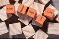 Wooden cube with inspirational text Faith, trust, believe, hope and love. Beautiful wooden table background. Business and Faith Royalty Free Stock Photo