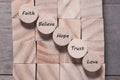 Wooden cube with inspirational text Faith, trust, believe, hope and love. Beautiful wooden table background. Business and Faith Royalty Free Stock Photo