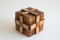 A wooden cube is placed on a plain white surface, creating a simple and minimalistic composition, Three dimensional, cube-shaped