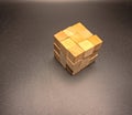 A wooden cube puzzle on a grey background Royalty Free Stock Photo