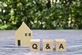 Wooden cube with Q and A on wood background.