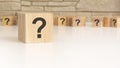 wooden cube shape with sign question mark symbol on white background