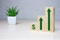 Wooden cube stack as a graph with arrows pointing up on white background. Concept of growth and success or rising successful Royalty Free Stock Photo