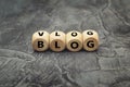 Wooden cube with word  blog & vlog on dark background Royalty Free Stock Photo