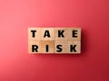 Wooden cube with the word TAKE RISK