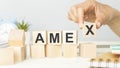 wooden cubes and AMEX, coins, the concept Royalty Free Stock Photo