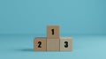 Wooden cubes as podium stand with first, second and third place. Wood blocks creative concept idea for business, winner, success, Royalty Free Stock Photo