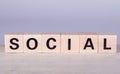 wooden cubes building the word Social, white background