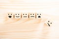 Wooden cubes that Express different emotions. smile face icon symbol on wooden cube on wooden background. concept of different Royalty Free Stock Photo