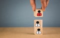 wooden cubes in the form of bosses and subordinates, personnel subordination on a blue background