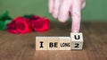 Wooden cubes form the expression 'I belong 2 U'.