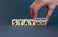 Wooden cubes form the expression `stay home, stay safe`. Beautiful grey background, copy space. Covid19 pandemic concept Royalty Free Stock Photo