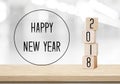 Wooden cubes with 2018 and happy new year over blur bokeh background, new year greeting card Royalty Free Stock Photo
