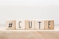 Wooden Cubes with hashtag the word cute and a little heart, social media concept