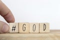 Wooden cubes with a hashtag and the word god, social media concept God is love concept text background Royalty Free Stock Photo