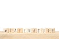 Wooden cubes with a hashtag and the words Safe Nature, social media concept, near white background