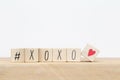 Wooden cubes with hashtag and XOXO hugs and kisses letters of love near white background, social media concept Royalty Free Stock Photo