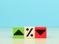 Wooden cubes with icon arrow up, down direction and percentage symbol.