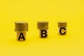 wooden cubes with the letters ABC and coins on top . Business. Finance Royalty Free Stock Photo