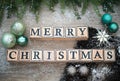 Wooden cubes with letters "Merry Christmas" on a festive background Royalty Free Stock Photo