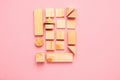 Wooden cubes lie in a row on pink background. The concept of using environmentally friendly natural materials Zero West.