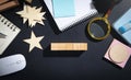 Wooden cubes, magnifying glass, wooden stars, notepad on the table
