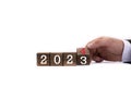 Wooden cubes. The next year is 2024. The year 2023 replaces 2024. The hand flips the dice, changing the years Royalty Free Stock Photo