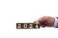 Wooden cubes. The next year is 2024. The year 2023 replaces 2024. The hand flips the dice, changing the years Royalty Free Stock Photo