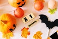 Wooden cubes with the numbers 31 october, pumpkins, autumn leaves on table . Flat layer. Halloween celebration concept