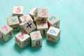 Wooden cubes with numbers on a turquoise wooden background