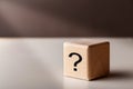 Wooden cubes with question mark in ray of light. FAQ concept Royalty Free Stock Photo