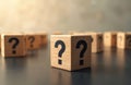 Wooden cubes with question marks arranged in rows. Symbol of confusion, inquiry, choice, problem, and finding answers. These Royalty Free Stock Photo
