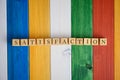 Wooden cubes in a row spelling the word Satisfaction