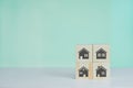 Wooden cubes with selling and renting houses or real estate concept property online symbol on background and copy space