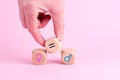 Wooden cubes showing the equality between two genders on a pink background