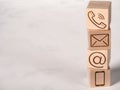 Wooden cubes with symbol telephone, email, address and mobile phone