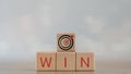 Wooden cubes with Target goal icon and win situation. Wooden cubes stack with text win situation. copy space Royalty Free Stock Photo