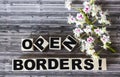 On wooden cubes the text Open Borders