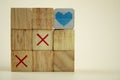 Wooden cubes tic tac toe board game with cubes heart on top Royalty Free Stock Photo