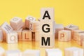 Word agm from wooden blocks with letters, concept Royalty Free Stock Photo
