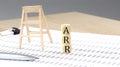 Word QTIP on wooden block on a black notebook with smartpone, credit card and magnifier Royalty Free Stock Photo