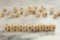 Wooden cubes with word Blacklist on white marble table, closeup