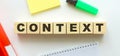 Wooden cubes with word CONTEXT on the office desk