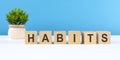 the word habits is written on wooden cubes on a light blue background Royalty Free Stock Photo