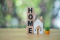 Wooden cubes with the word home placed with home model and miniature cactus. Real estate business Royalty Free Stock Photo