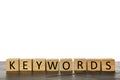 Wooden cubes with word KEYWORDS on grey table