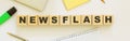 Wooden cubes with word NEWSFLASH on the office desk Royalty Free Stock Photo