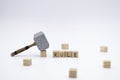 The wooden cubes with the word RULE and the weapon around against white background. The medieval hammer on a wooden cube