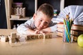 Wooden cubes with word school in hands of little boy at home. Conceptual image about child rights, education, childhood and